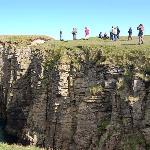 Geopark Shetland - Scotland. Site Name: Cletts, Dunrossness. About 350 million years ago Shetland was lying near the equator and had a desert environment. The cliffs here show dune sandstones and the direction of the bedding enables us to tell the direction of the prevailing wind during their formation. The group of geo-tourists are spending a day looking at Devonian environments.